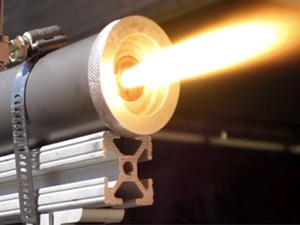 a photograph of a small rocket motor firing